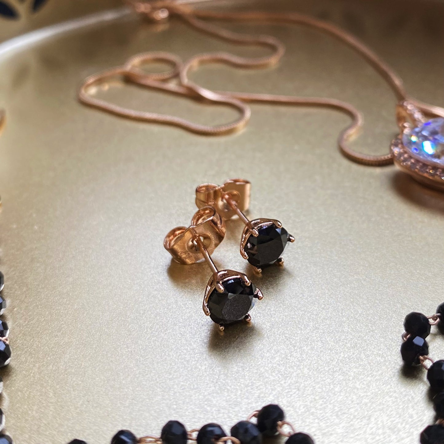 Gold-plated stud earrings with black crystal